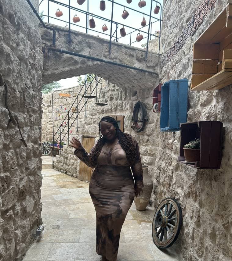 Tobi in the stone courtyard of the cave hotel